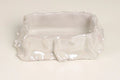 A small, rectangular ceramic dish with a wavy, ruffled rim and a glossy, iridescent finish, photographed on a plain off-white background.